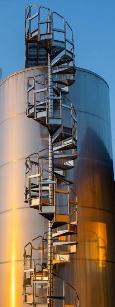 backyard winery sunset with metal wine storage tanks 1
